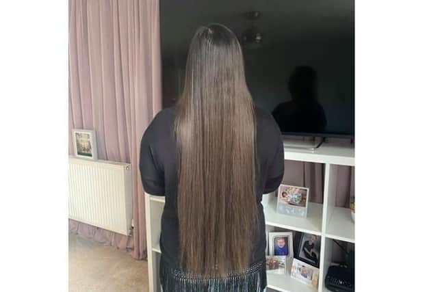 Georgina's hair is so long that she can sit on it
