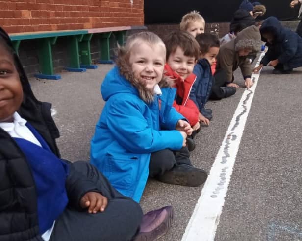 Pupils laying coins in to raise money for MK Hospital