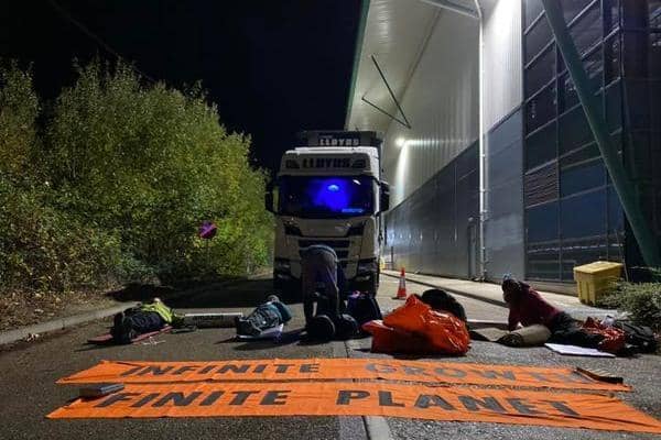 Image shows Extinction Rebellion campaigners at an Amazon depot this morning