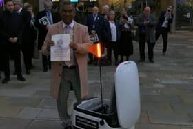The mayor of MK prepares to send the bid off by robot