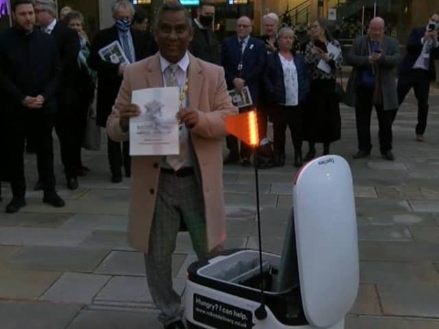 The mayor of MK prepares to send the bid off by robot