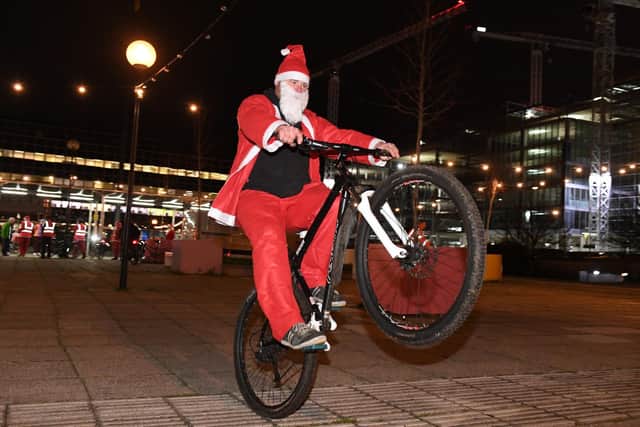 Cycling Santas who had gathered at Station Square rode up Midsummer Boulevard to Campbell Park, around the Light Pyramid and back, with a stopover to entertain the crowd outside MK Theatre