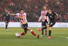 Scott Twine gets a shot away at against Lincoln City