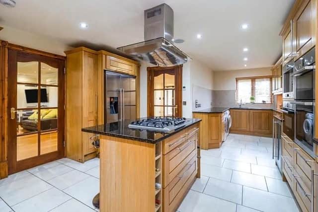 Kitchen 23' max x 14' max ( 7.01m max x 4.27m max )
The extensive fitted kitchen offers a mix of wall and base level units, work surfaces incorporating two sink units. Integrated double electric oven, microwave, beverage centre, coffee machine and dishwasher. There is also a hot water tap, space for washing machine and fridge/freezer and island with five ring gas hob.