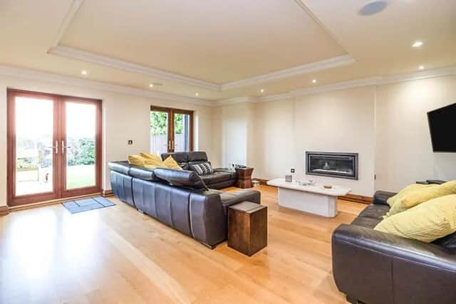 Lounge 18' 3" x 17' 9" ( 5.56m x 5.41m )
The spacious lounge features double glazed patio doors to rear aspect, electric fireplace, television and telephone points with wooden flooring, coving, integrated speakers in ceiling and air conditioning. Doors  lead to kitchen and dining room.