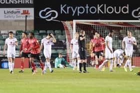 Lincoln celebrating after one of their four second-half goals at Sincil Bank on Tuesday night