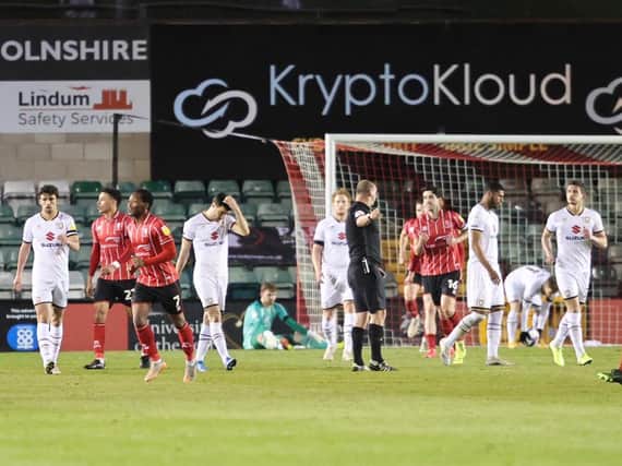 Lincoln celebrating after one of their four second-half goals at Sincil Bank on Tuesday night