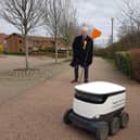 John Howson with a delivery robot in Milton Keynes