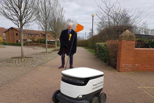 John Howson with a delivery robot in Milton Keynes