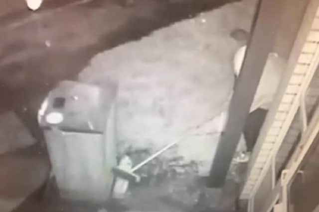 The thief using a broom to steal milk is caught on CCTV