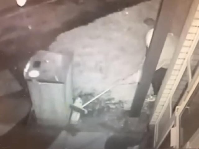 The thief using a broom to steal milk is caught on CCTV