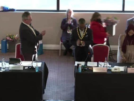 Cllr Andrew Geary, left, applauds his successor Cllr Mohammed Khan