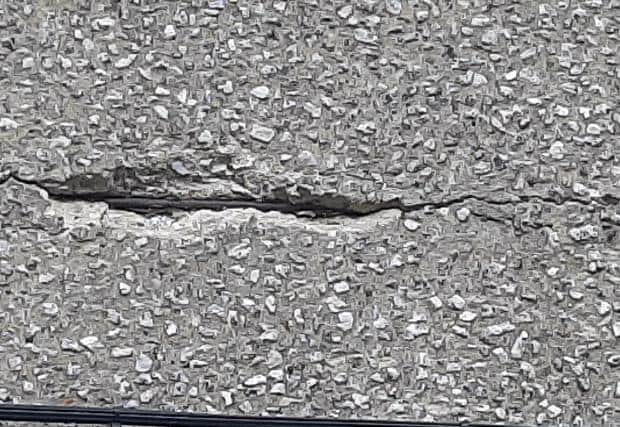 A deep crack in the concrete