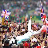 Lewis Hamilton celebrates his Silverstone victory in 2019 by crown-surfing