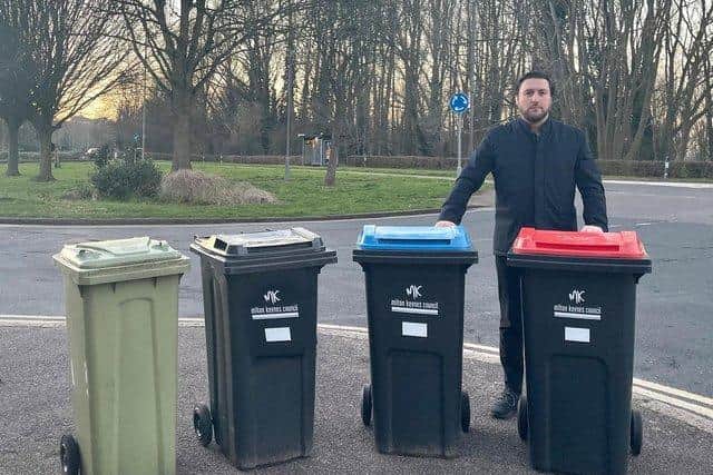 Labour council leader Pete Marland demonstrates the four new wheelie bins to be introduced in MK