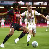 Tyrone Mings takes on Rhys Healey when Dons and Bournemouth last met