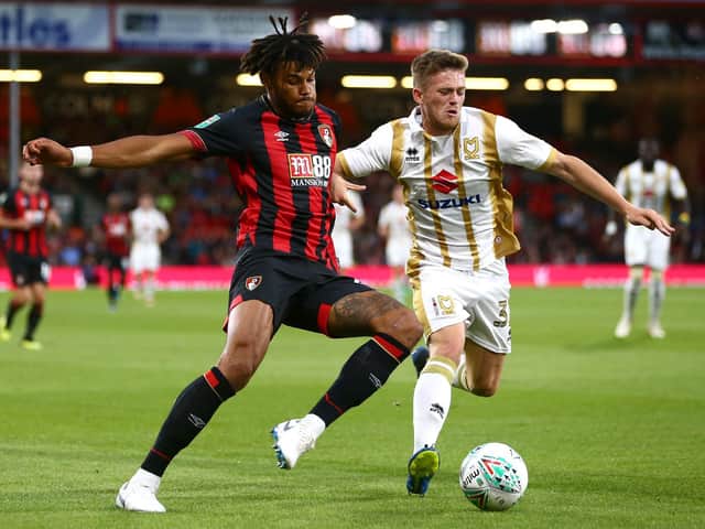 Tyrone Mings takes on Rhys Healey when Dons and Bournemouth last met