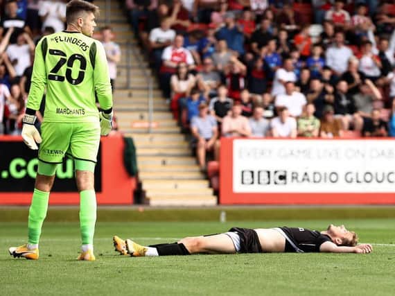 MK Dons' Charlie Brown is left flat on his back after missing a chance in the first half at Cheltenham Town