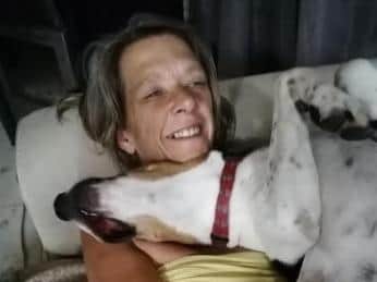 Lesley enjoys a cuddle with one of her dogs