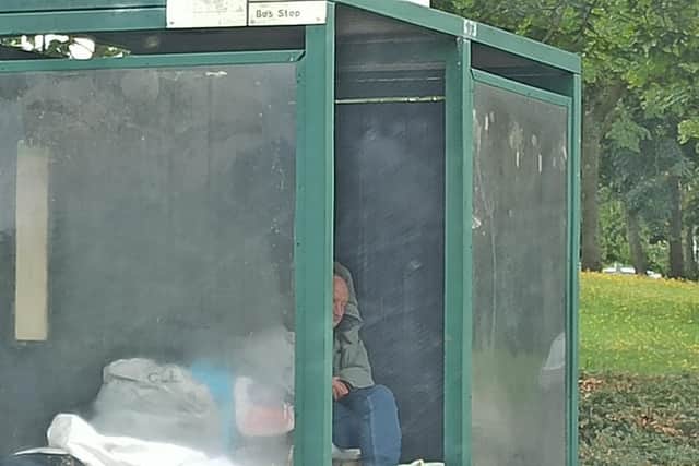 John in his bus shelter home