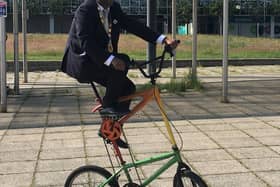 Clever Mayor Khan shows his skills on a trick cycle