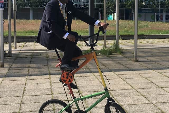 Clever Mayor Khan shows his skills on a trick cycle