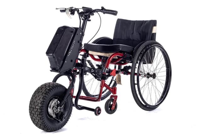 The attachment converts a wheelchair into a bike