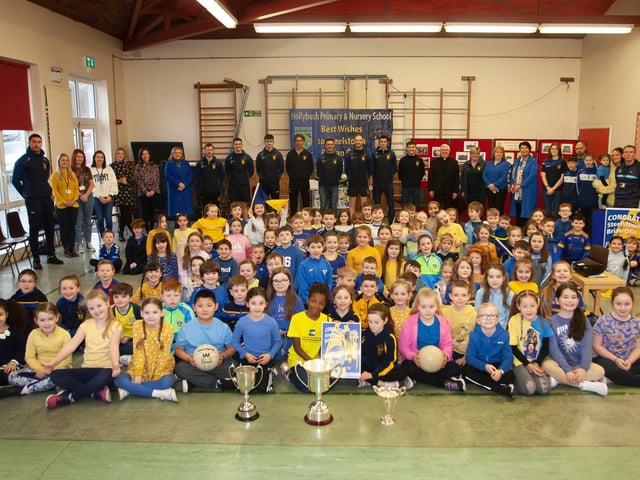 Some of the younger children at Hollybush Primary School pictured with the trophies won this season by local club Steelstown Brian Ogs, including the All Ireland trophy. (Photo: Jim McCafferty)