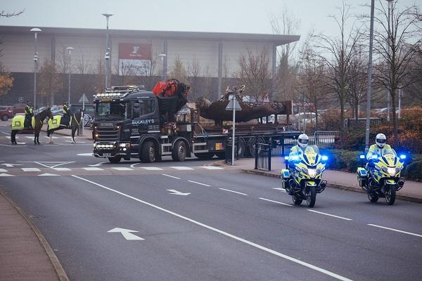 Police escorting the giant sculpture into the Stadium:MK area