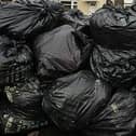 The mountain of black sacks is gorwing every day