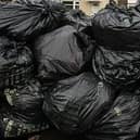 The mountain of black sacks is gorwing every day