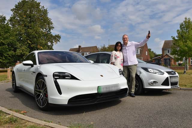 Omaze Porsche Taycan winner Laurence Rogers and wife Renny with his old Ford Focus