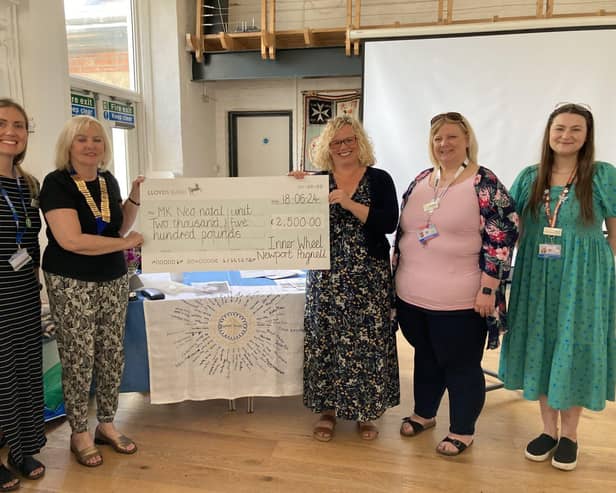 MK Hospital volunteers receiving cheque from Inner Wheel member