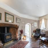 The living room in the property, complete with luxurious comfortable sofas and a wood burning fire.