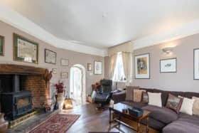 The living room in the property, complete with luxurious comfortable sofas and a wood burning fire.
