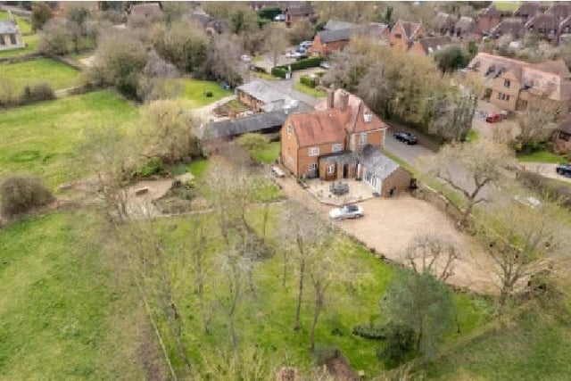 This aerial shot shows the well-maintained lawned garden that is attached to the home, as well the countryside surroundings the new owner can enjoy.