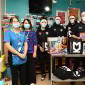 Members of the first team visited Milton Keynes Hospital on Thursday to hand out presents