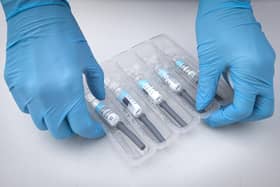 File photo dated 26/09/2020 of a nurse preparing flu vaccine jabs.
