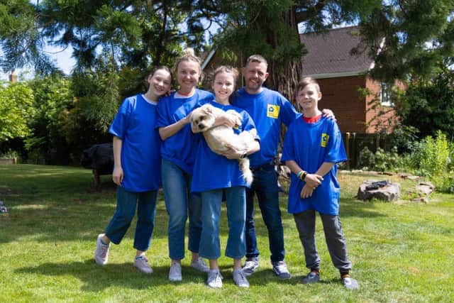 Some of the Ukrainian refugees pictured with their pet dog at Mr Edwards' home in Willen