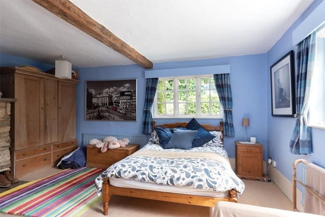 The spacious second bedroom offers access to the loft