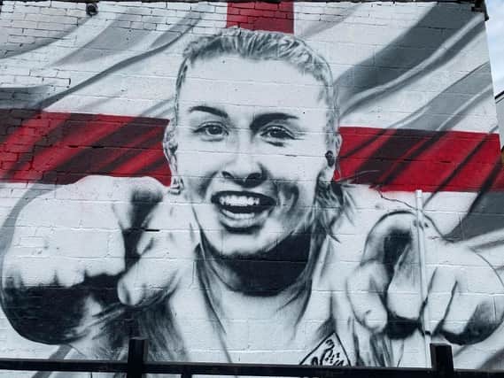 The  mural shows Leah's beaming face