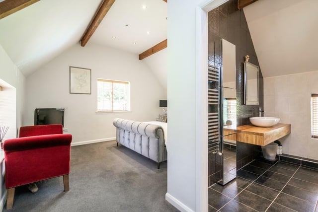 The master bedroom has a raised vaulted ceiling with windows to rear and side aspects. The en-suite comprises low level WC, wash hand basin set into a worktop, and a large walk-in shower.