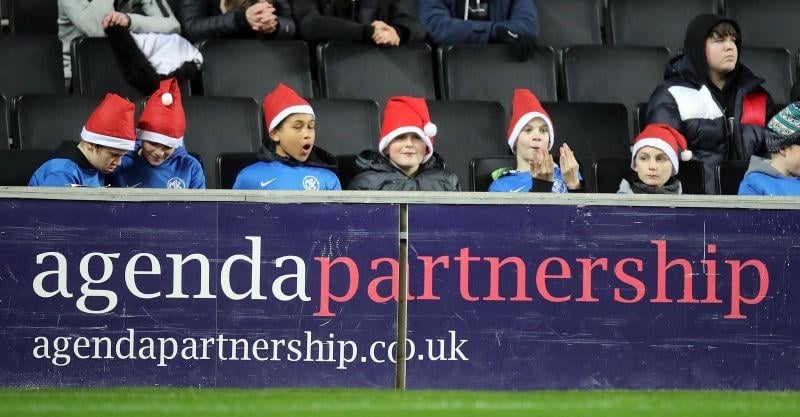 Young fans wearing Santa hats look on during the Sky Bet League One match between Milton Keynes Dons and Plymouth Argyle at Stadium MK on December 08, 2021.