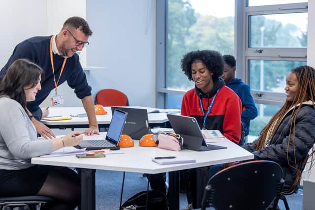 A level teacher Tom Beach with students at Milton Keynes College. From left to right, Holly Couchman, Jehiel Nelson and Iyinoluwagbemi Akinyemi