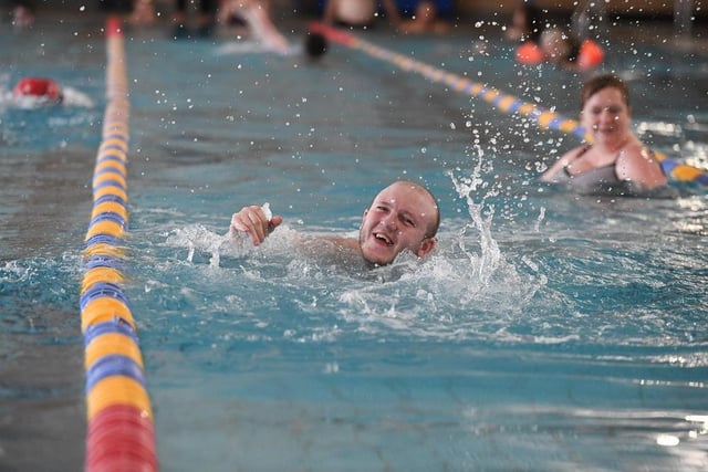 This swimmer flashes a smile mid-length.
