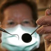 A patient's eye view, as a dentist poses for the photographer. Photo by Peter Macdiarmid/Getty Images