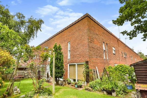 The house is a corner terrace on an L-shaped plot