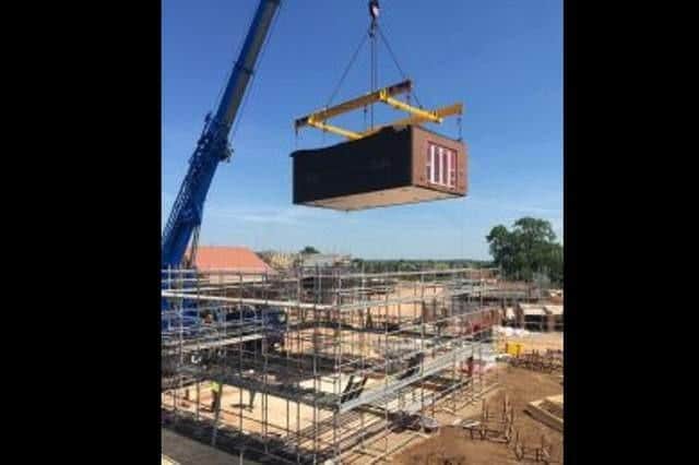 The modular homes are built in a factory and then craned into place