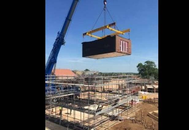 The modular homes are built in a factory and then craned into place
