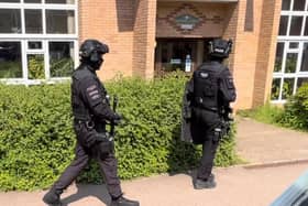 Armed police entering the elderly people's complex on Two Mile Ash on Milton Keynes